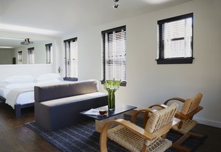 This Boutique Hotel Loves its City Like No Other - Photo 9 of 14 - The rooms offer a rough-hewn industrial vibe softened with cozy textiles and more vintage furniture. ASH worked with a rug dealer in Brooklyn to source rugs direct from Turkey. On the beds, you’ll find blankets from Elder Statesman and Brahms Mount and perfectly crisp sheets from Matouk. Providence's history is firmly rooted in industry and Heckman sought to feature furniture that represents work from present-day companies. Local fabricator Iron Origami produced ASH's design for the bed frames and writing desks found in each room.