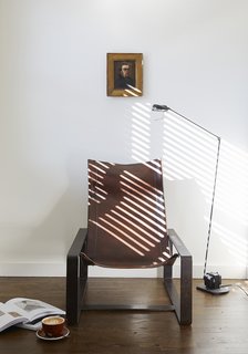 This Boutique Hotel Loves its City Like No Other - Photo 11 of 14 - In addition to the uniform beds, sconces, writing desks, and chairs found in each room, you’ll find unique antiques like this Tomasso Cimini floor lamp and chair by Jean-Pierre Nicolini.