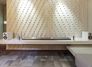 No Walls Were Knocked Down in the Making of This SF Pad - Photo 2 of 7 - Inspired by a dress made out of razor clam shells by the late fashion designer Alexander McQueen, the designers created a custom wall with individually laid pieces of Island Stone tile. It accents a minimalist EcoSmart fireplace. 