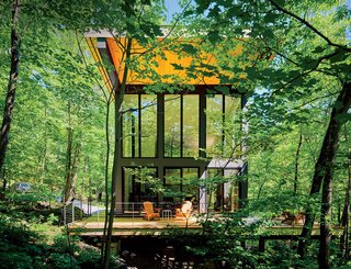 A cantilevered cabin designed by R D Gentzler blends into the forest, even as it hovers above a 20-foot drop-off. Its south face is almost entirely glass, but a roof canopy limits solar gain. "We sit on the deck all afternoon watching the trees, and the time just flies by," says resident Maricela Salas.