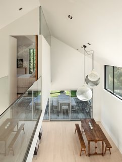 Pendant lamps by Moooi are suspended from the double-height ceiling.