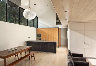 This Former Garage Is Clutter Free - Photo 3 of 4 - Marc Lithgow custom designed the American oak kitchen cabinets. The floors, and the ceiling above the lounge, are whitened maple.