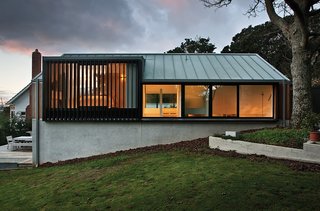 This Former Garage Is Clutter Free - Photo 4 of 4 - Made from anodized aluminum, the mechanical louvers surrounding the master bedroom provide privacy while letting in light.