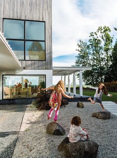 A Lakeside Home Brings a Scandinavian Sensibility to the Midwest - Photo 1 of 6 - Julie Brogan’s three grandchildren—frequent visitors to her lakeside house in Sturgeon Bay, Wisconsin—can often be found playing on the crushed slate in the courtyard or romping in a corridor that has come to be known as the "galloping hall."