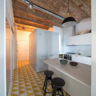 In Barcelona, Vaulted Ceilings Are Always a Win - Photo 3 of 5 - The most striking feature of the original apartment was the vaulted ceilings with wood beams, which were kept intact. A geomteric hydraulic mosaic flooring covers the kitchen. 