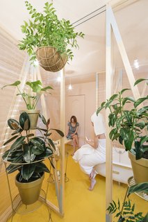 A Quirky Renovation Brings an Indoor Garden to the Center of Madrid - Photo 1 of 6 - A canary yellow–floored bathroom with corrugated plastic walls is the centerpiece of the renovation. 