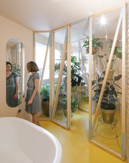 A Quirky Renovation Brings an Indoor Garden to the Center of Madrid - Photo 2 of 6 - A small greenhouse with a drip irrigation system is place between the two most humid areas in the apartment: the bath and a smaller, more private shower room. It's the only room without underfloor heating in the entire apartment to ensure that the plants don't dry out.