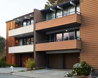 The new house, at left, still complements the neighboring unit, while introducing a clean, modern palette.