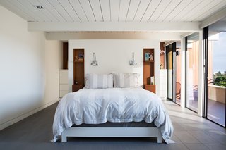 The design team decided to combine two smaller bedrooms into one more comfortable master suite with a large closet and dressing area. They also eliminated a fourth bedroom, further improving the circulation of the house.