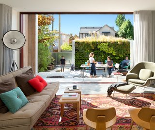 A Wild Garden Leaps Off the Walls of This Backyard Build - Photo 2 of 4 - A sliding glass Western Window Systems door dissolves the boundary between indoor and outdoor.