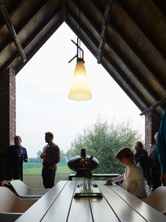 An open-air terrace off the kitchen features a Marina table and Captain chairs from Extremis.