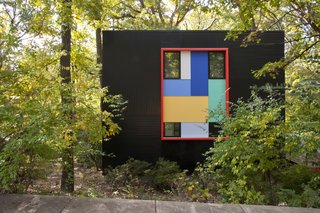 This Multicolor Facelift Owes Much to Modern Art - Photo 2 of 4 - A backdrop of Valspar Fluropon coating in Black accentuates the bursts of turquoise, dandelion yellow, and other colors framing the windows. The eye-catching palette is inspired by San Francisco artist Richard Diebenkorn’s Ocean Park series. 