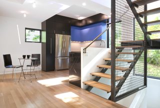 This Multicolor Facelift Owes Much to Modern Art - Photo 4 of 4 - Inside, where the dining and living spaces were reconfigured, the vibrant colors continue with smaller accents like the azure cabinetry. 