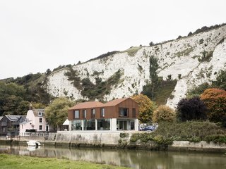 Bold House Doubles as a British Town's Welcome Sign - Photo 1 of 6 - Sandy Rendel Architects replaced an old workshop with a striking new home in Lewes, East Sussex, England. The structure is located right at the edge of the town, in a spot that formerly functioned as a wharf to an adjacent quarry. Due to its prominent siting, the planning authority wanted to see a bold design that would signal the town's entrance. The building shell, made of SIPS, was prefabricated offsite, allowing for significant time savings in construction.