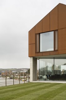 Bold House Doubles as a British Town's Welcome Sign - Photo 5 of 6 - The upper story is clad in a decorative rainscreen of Cor-Ten steel mesh, chosen in part for its tone, which complements the red clay brick used locally. "The external materials were all selected to be robust and self-finished," says Rendel. "They will weather naturally, develop character and patina, and require very little maintenance." 