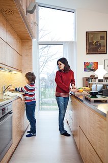 This Home Will Make You Want to Build Your Own Sauna - Photo 2 of 10 - The kitchen is outfitted with a built-in refrigerator by Norcool and an AEG cooktop and oven.