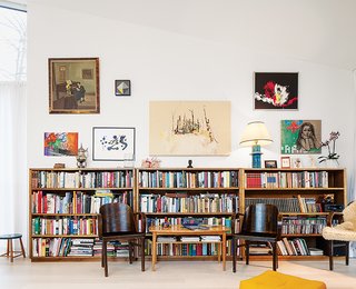 This Home Will Make You Want to Build Your Own Sauna - Photo 7 of 10 - The bookshelves lining the walls of the living room were inherited from family.