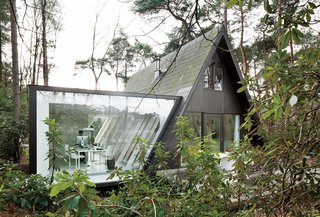 This Minimal Addition Looks Magical in the Belgian Forest - Photo 2 of 4 - Van Beek’s extra space is home to her office. She works on a Tense table by Piergiorgio and Michele Cazzaniga and Flow chairs by Jean Marie Massaud, both for MDF Italia.