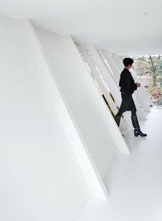 This Minimal Addition Looks Magical in the Belgian Forest - Photo 4 of 4 - The original building’s structural framework is a series of sloping studs; Verschueren left these intact on the side of the house to be enlarged, matching them to new vertical studs in the frame constructed for the extension. 