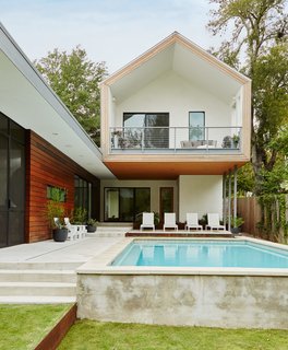 Architect Burton Baldridge’s design for a house in Austin features a cantilevered upper volume with a gabled profile that was in part inspired by the work of Dutch architects MVRDV. It juts out over the patio, outfitted with chaise longues by Harbour Outdoor and Adirondack chairs by Loll.
