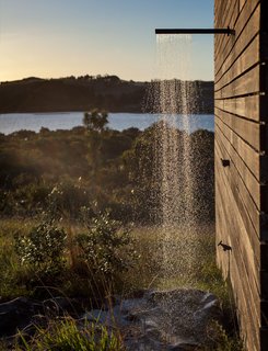 Just like the interior, the outdoor shower is an exercise in reduction and contrast: It’s merely a boulder placed under a showerhead on the side of the building. "If you really strain your eyes, you can see perhaps one other house," Cheshire says of the vista.