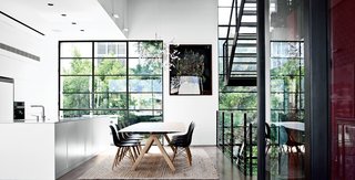 Modern High-Rise Town House in Tel Aviv - Photo 6 of 7 - The family eats at Table B by Konstantin Grcic for BD Barcelona. The Plastic side chairs are by Charles and Ray Eames for Vitra. 