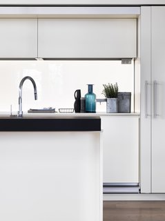 Pretty on the Inside: The Luxe Residences of Milan's Vertical Forest - Photo 5 of 6 - The kitchen—a customized version of the Dada Tivalì system, designed by Dante Bonuccelli, with a Hi-Line6 hood and island—was imaged as a white monolith that can be hidden behind doors tucked within the framework. 