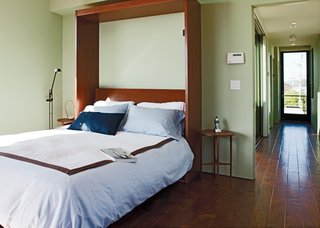 Rising Tides Are No Match for This Coastal Home - Photo 6 of 10 - The bed folds vertically into the wall to open up the living space for lounging or entertaining. 