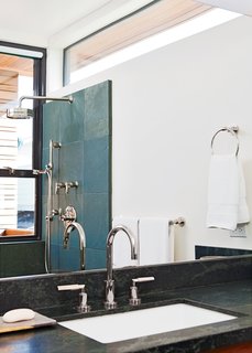 Rising Tides Are No Match for This Coastal Home - Photo 7 of 10 - Even the bathroom features narrow ocean views. 