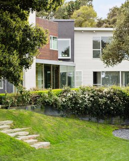 "We sculpted the lawn, so it became layered, almost like an amphitheater," says Wyllie, who salvaged stones from the site to create steps down to the yard. 