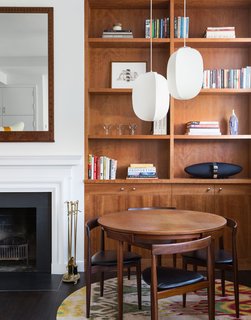 725 Square Feet and Loads of Modern Gems - Photo 2 of 6 - The dining set was designed by midcentury Danish deisgner Hans Olsen. It's illuminated by a duo of Mori Gourd pendants, also by Rich Brilliant Willing.