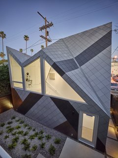 This Entertaining Guesthouse and Studio Will Inspire You to Start Making Art - Photo 1 of 5 - Concerned that studio was too big compared to other homes in the neighborhood, the 1,060 square-foot structure references the dazzle pattern, a camouflage technique used by WWII battleships. Monti was inspired by the way the pattern "helps break down the scale of a large ship." Modal Design choose the zinc colors that fit with the neighborhood. "From afar and at certain angels, it is hard to see where one starts and one ends." says Monti. 