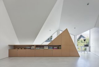 This Entertaining Guesthouse and Studio Will Inspire You to Start Making Art - Photo 4 of 5 - The storage unit is built with a vertical grain oak. Modal Design worked with cabinet makers Scanlon Construction to follow the specific roof angles. 