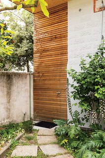 A cedar-clad door in the front provides a shortcut to the backyard. 