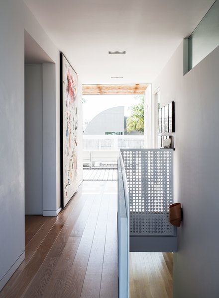 Amid a Hotbed of Architecture, This Home Holds Its Own - Photo 5 of 9 - Panoramic windows are sited at either end of the staircase. The metal-screen railing, punctured by small round apertures, continues alongside the perimeter of the terrace; it was fabricated by Tortoise Industries. 