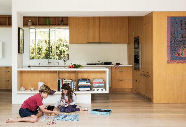 Amid a Hotbed of Architecture, This Home Holds Its Own - Photo 9 of 9 - The appliances are by Miele, and the sink and faucet are by Blanco. In the dining area, a Link Suspension lamp by LZF hangs above the Minotti table and chairs. The artwork is by Nathan Coley. 