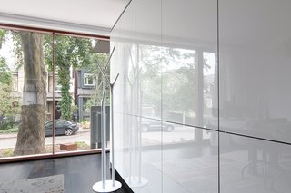 On the ground floor, freestanding cabinetry with a gloss lacquer finish by Bulthaup separates the entryway from the kitchen and dining area. 