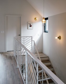 Modern Metals designed railings to echo the herringbone exterior. 