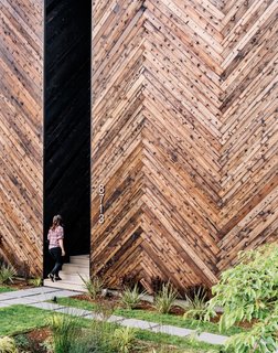 Passive House guidelines, like thick insulation, can often result in very simple forms, she says. Here, a recessed entrance in the shou sugi ban front facade provides privacy without complicating the design. 