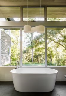 A Meadow With Amenities - Photo 8 of 10 - In the master bath, a Duna pendant by El Torrent hangs above a Blu Stone tub. 