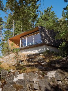 Perched over a cliff face, the hooded deck of the Gambier Residence reads like a ship’s prow over Howe Sound, the scenic waters near Vancouver. 
