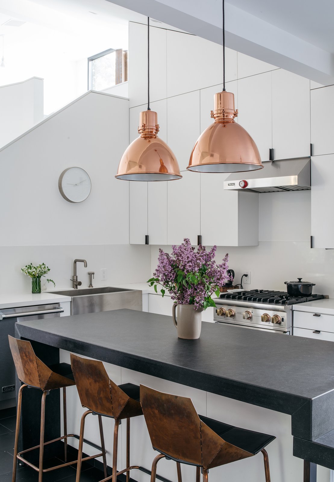 The kitchen is outfitted with a granite countertop and custom casework; the hardware is by Tom Kundig