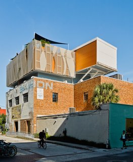 High Above Traditional Charleston, a Modern Home Finds its Roost - Photo 7 of 7 - Fiberglass composite louvers, which Rich can control from the deck, block out views from a nearby college dorm and parking garage. 