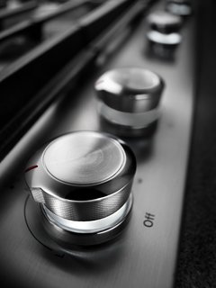5 Essential Design Elements of the Modern Kitchen - Photo 3 of 6 - 3) Ease of use<br>Accessible design is becoming a central conversation in the design world. More than ever, homeowners are looking for ease of use—products that can be smoothly operated and will help create a seamless kitchen space for all. A cross-hatch texture appears on the bladed knobs of KitchenAid burners, making it easy to move the dials through different heat levels. The knobs are also back-lit so the user knows when the burner is on.