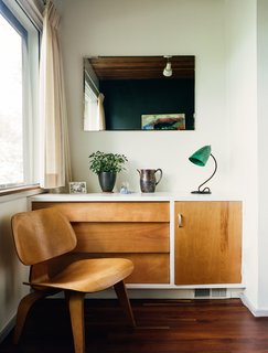 Kansas City Royal - Photo 5 of 15 - Built-in details include a dresser that pairs with an Eames molded plywood lounge chair in a guest bedroom. 