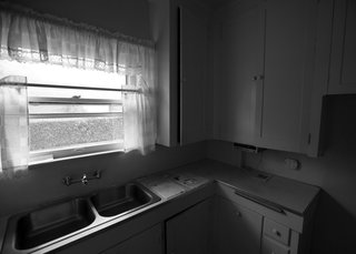 The addition of French doors and integrated white-quartz countertops made the space much brighter than it previously appeared.