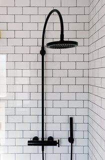 Savoy Graphite floor tiles by Ann Sacks complete the shower. 