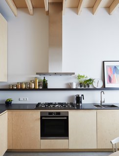New Kid on the Block - Photo 5 of 10 - The birch plywood cabinets, designed by Jeffries, are paired with engineered wood countertops by Valchromat and appliances by Bosch. 