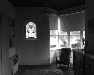 Nest Architects restored original details including bay windows, stained glass, and timber floors at the front of the house. 