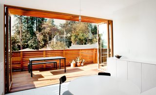 Check Back - Photo 11 of 14 - A proposed wall of sliding glass doors morphed into a NanaWall system after the residents were assured the latter was more likely to be approved by the town. When folded back, the panels provide a seamless connection to the deck. 